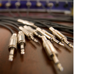 серебристые аудиоразъёмы на фоне аппаратуры